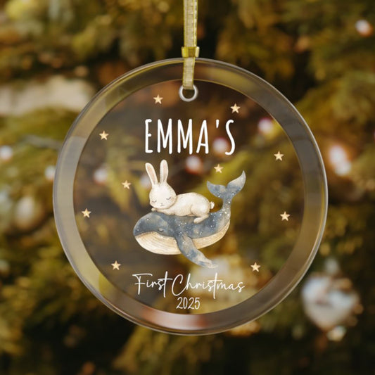 Personalized newborn Christmas glass ornament featuring a sweet bunny sleeping on a whale, stars in the background, custom baby name and year keepsake for holiday tree