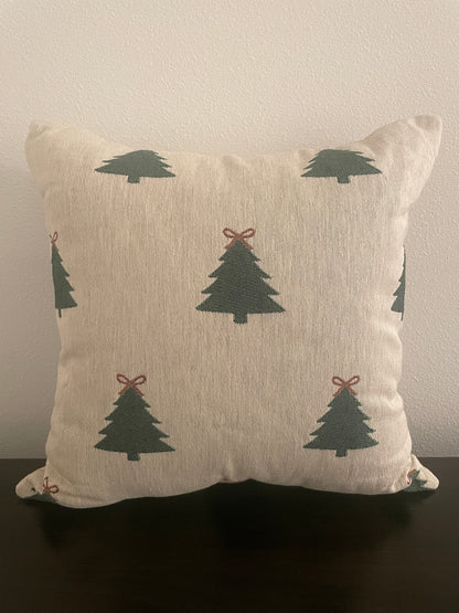 Neutral woven Christmas pillow featuring green Christmas trees with red bows, perfect for rustic farmhouse or minimalist holiday décor.