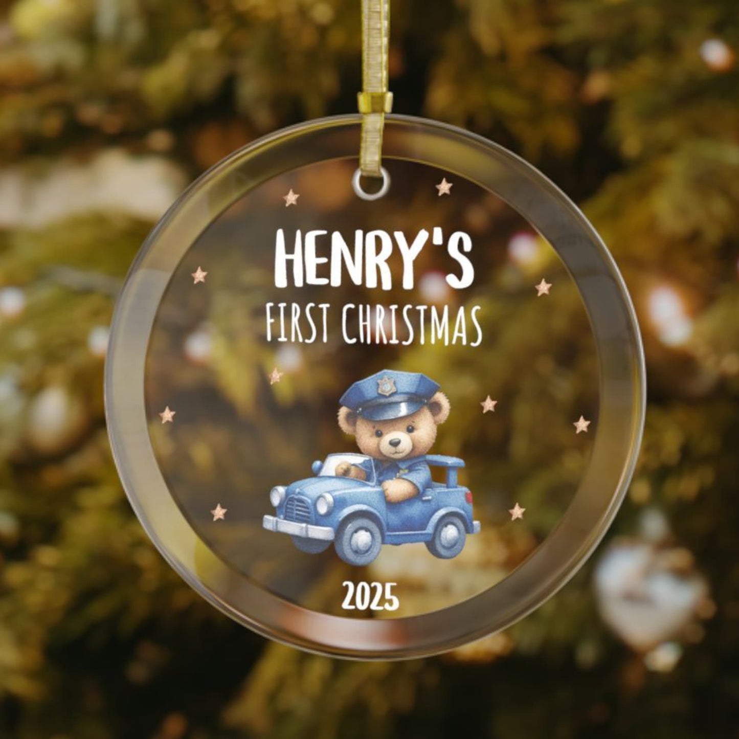 Personalized baby’s first Christmas glass ornament with teddy bear driving a toy police car, stars scattered in the background, custom name and year keepsake, holiday decoration for Christmas tree