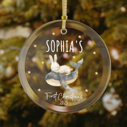 Personalized baby’s first Christmas glass ornament with bunny resting on a whale, stars scattered in the background, custom baby name and year keepsake, holiday decoration for Christmas tree